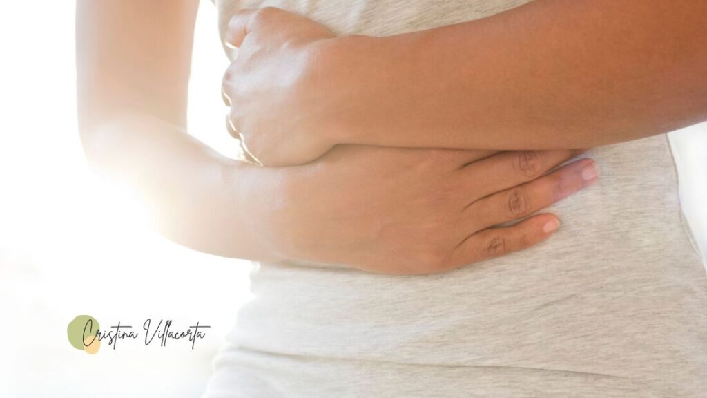 Person holding her tummy with colic from IBS